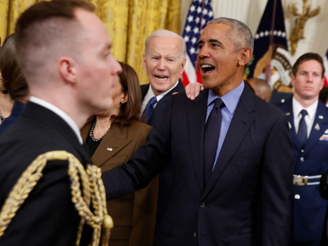 WASHINGTON, DC - APRIL 05: Former President Barack Obama (C) and President Joe Biden greet friends and guests at the conclusions of an event to mark the 2010 passage of the Affordable Care Act in the East Room of the White House on April 05, 2022 in Washington, DC. With …