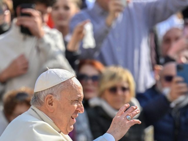 Pope Francis blesses attendees as he arrives on April 20, 2022 for the weekly general audi