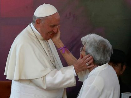 Pope Francis (L) greets an elderly woman during his visit at Padre Hurtado Sanctuary in Santiago, on January 16, 2018. The pope landed in Santiago late Monday on his first visit to Chile since becoming pope, and his sixth to Latin America, a trip that will also take him to …