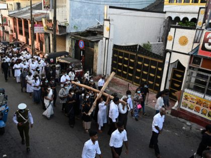 Christian devotees take part in the annual Way of the Cross procession, which symbolises the final journey of Jesus Christ before he was crucified, on Good Friday in Colombo on April 15, 2022. (Photo by ISHARA S. KODIKARA / AFP) (Photo by ISHARA S. KODIKARA/AFP via Getty Images)
