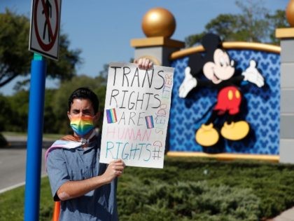 ORLANDO, FL - MARCH 22: Disney employee Nicholas Maldonado holds a sign while protesting outside of Walt Disney World on March 22, 2022 in Orlando, Florida. Employees are staging a company-wide walkout today to protest Walt Disney Co.'s response to controversial legislation passed in Florida known as the “Don’t Say …