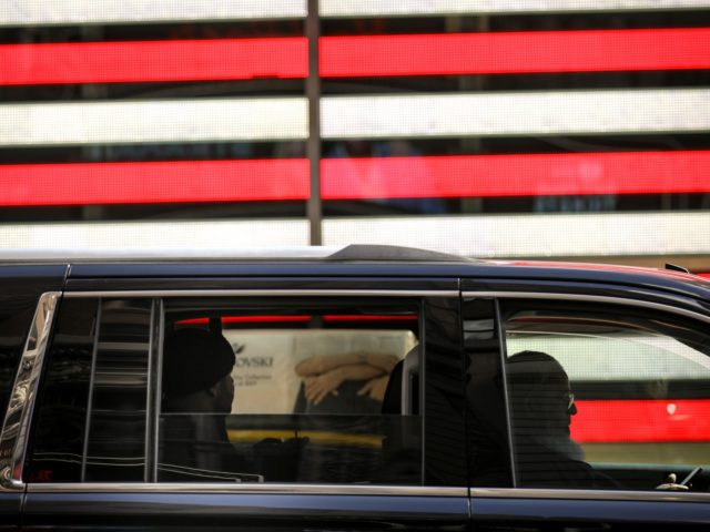 NEW YORK, NY - MARCH 19: A man drives a for-hire vehicle through Times Square, March 19, 2