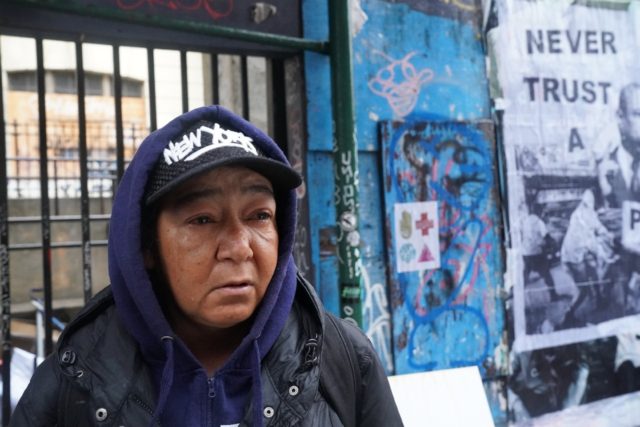 A homeless woman named Jordan looks on as Mayor Eric Adams orders homeless camps removed i