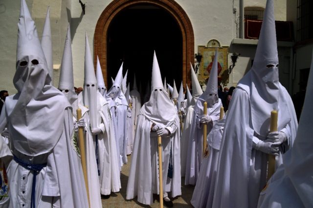 The parades feature dozens of people dressed in religious tunics and distinctive pointy ho