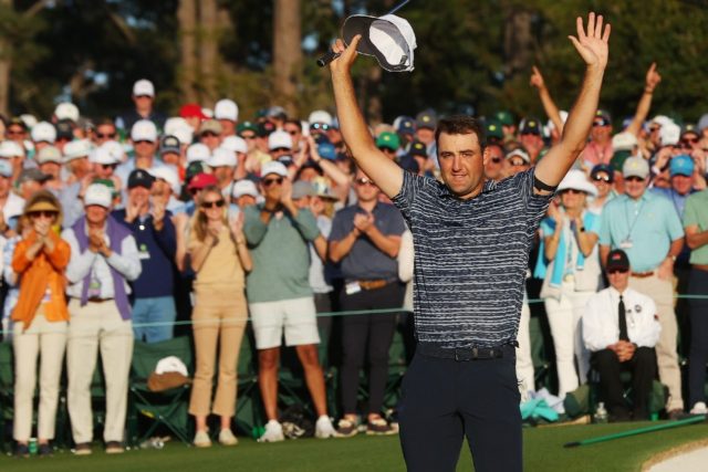 World number one Scottie Scheffler celebrates on the 18th green after winning the 86th Mas