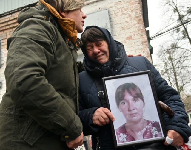 Nadia Kovalenko holds a photograph of her daughter Inna, who was killed in Bucha last mont