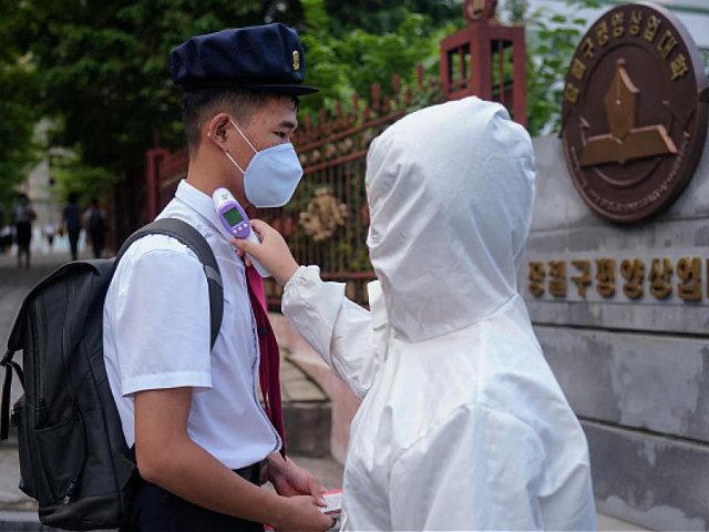 Students of the Pyongyang Jang Chol Gu University of Commerce undergo temperature checks before entering the campus, as part of preventative measures against Covid-19, in Pyongyang on August 11, 2021. (Photo by KIM Won Jin / AFP) (Photo by KIM WON JIN/AFP via Getty Images)