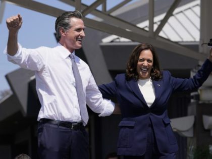 Vice President Kamala Harris stands on stage with California Gov. Gavin Newsom as she arri