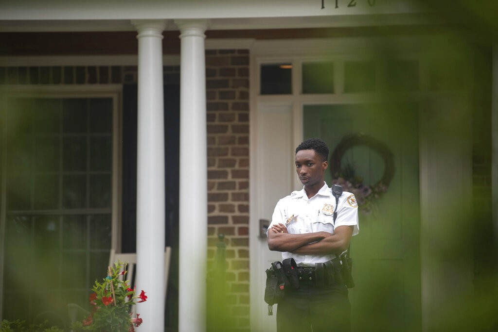 A U.S. Supreme Court police officer stands outside the home of Justice Samuel Alito on Thursday, May 5, 2022, in Alexandria, Va. A draft opinion suggests the U.S. Supreme Court could be poised to overturn the landmark 1973 Roe v. Wade case that legalized abortion nationwide, according to a Politico report released Monday. Whatever the outcome, the Politico report represents an extremely rare breach of the court's secretive deliberation process, and on a case of surpassing importance. (AP Photo/Kevin Wolf)