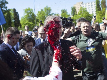 Russian Ambassador to Poland, Ambassador Sergey Andreev is covered with red paint in Warsaw, Poland, Monday, May 9, 2022. Protesters have thrown red paint on the Russian ambassador as he arrived at a cemetery in Warsaw to pay respects to Red Army soldiers who died during World War II. Ambassador …