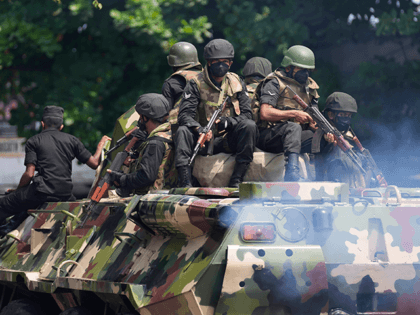 Sri Lankan army soldiers patrol during curfew in Colombo, Sri Lanka, Wednesday, May 11, 2022. Sri Lanka's defense ministry ordered security forces on Tuesday to shoot anyone causing injury to people or property to contain widespread arson and mob violence targeting government supporters. (AP Photo/Eranga Jayawardena)