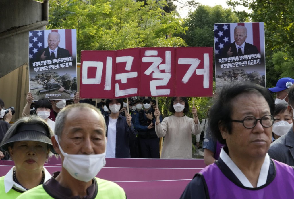 Protesters march during a rally to oppose a visit by U.S. President Joe Biden near the presidential office in Seoul, South Korea, Friday, May 20, 2022. The signs read "Withdrawal of the U.S. troops." (AP Photo/Ahn Young-joon)