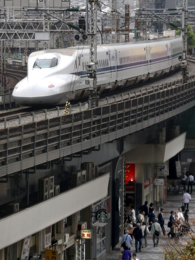 In this Sept. 24, 2014 photo, a Shinkansen bullet train runs by Yurakucho Station after le
