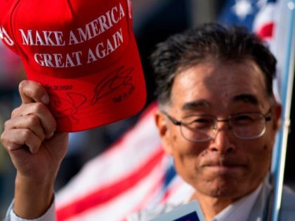 A Trump Supporter from Japan his hat signed by the president as a group gathers to show support for the President on October 23, 2020 in Scranton, Pennsylvania. (KENA BETANCUR/AFP via Getty Images)