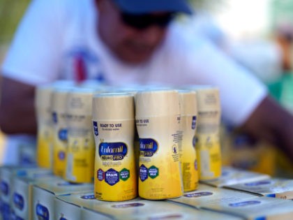 Infant formula is stacked on a table during a baby formula drive to help with the shortage