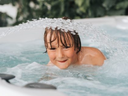 Boy enjoying outdoor hot tub