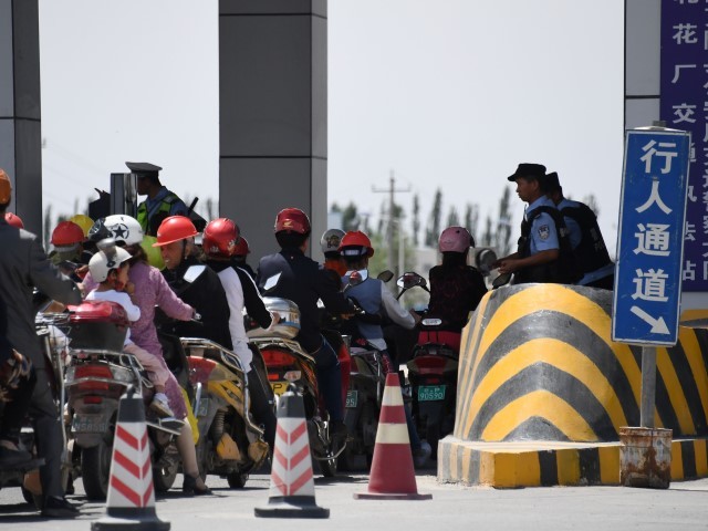 This photo taken on June 4, 2019 shows a police checkpoint on a road near a facility believed to be a re-education camp where the majority of Muslim ethnic minorities are detained, north of Akto in the region. western Chinese Xinjiang.  Up to a million ethnic Uyghurs and other minorities, mostly Muslims, are believed to be held in a network of internment camps in Xinjiang, but China has given no figures, describing the facilities as 