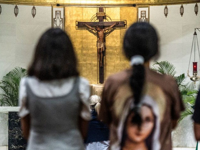 Parishioners pray during mass in St Joseph's Catholic Church near the site of a collapsed building in Surfside, Florida, north of Miami Beach, on June 30, 2021. (GIORGIO VIERA/AFP via Getty Images)
