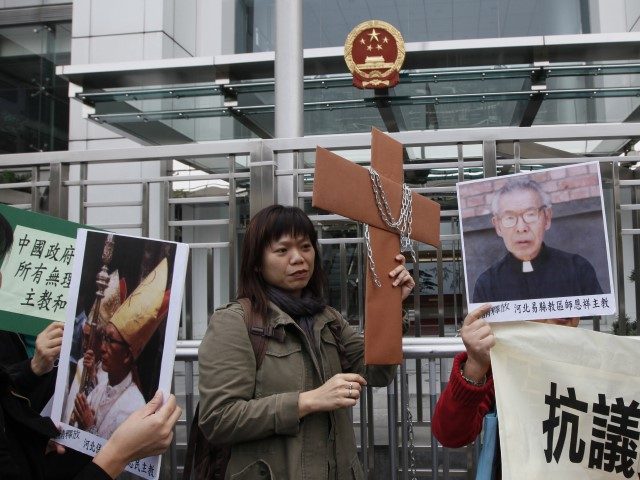 Protesters from Justice & Peace Commission of The Hong Kong Catholic Diocese hold the pict