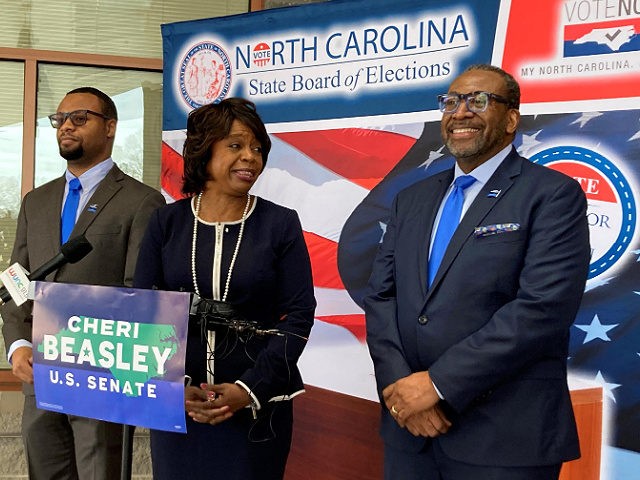 Democratic U.S. Senate candidate Cheri Beasley, center, laughs with husband Curtis Owens,