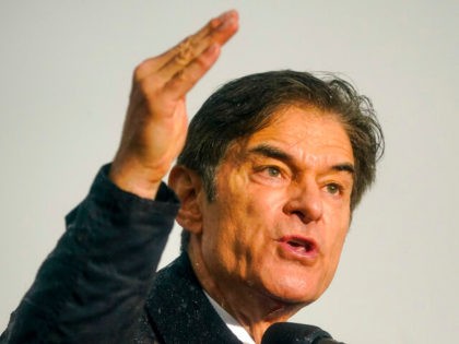 Pennsylvania Senate candidate Mehmet Oz speaks in a rainstorm at a campaign rally in Green