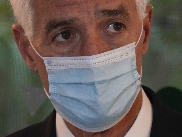U.S. Rep. Charlie Crist (D-FL) wears a mask as he listens to other speakers at a press conference to announce a solar plower initiative for the state, Wednesday, Feb. 9, 2022, in South Miami, Fla. The Democratic U.S. congressman is running for governor of Florida.