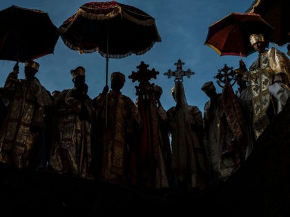 TOPSHOT - Priests attend the celebration of Genna, the Ethiopian Orthodox Christmas, at Saint Mary's Church, in Lalibela, 645 kilometres (400 miles) north of Addis Ababa, in the Amhara region bordering the northern region of Tigray on January 7, 2022. - Just weeks ago, the UNESCO-listed site and its astonishing …