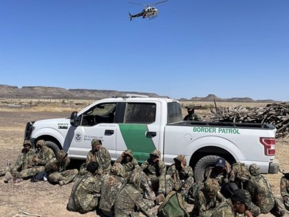 A Texas DPS helicopter crew guides Border Patrol agents in the Big Bend Sector to a group of 32 camo-wearing migrants. (Texas Department of Public Safety)