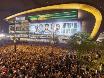 FILE - Fans cheer outside Fiserv Forum after the Milwaukee Bucks defeated the Phoenix Suns in Game 6 of the NBA basketball finals to win the NBA championship Tuesday, July 20, 2021, in Milwaukee.