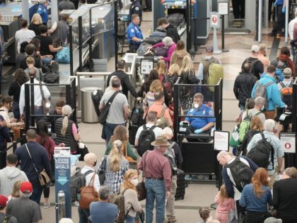 FILE - Travelers queue up move through the north security checkpoint in the main terminal of Denver International Airport, Thursday, May 26, 2022, in Denver. Airline travelers are not only facing sticker shock this Memorial Day weekend, the kick off to the summer travel season, but they're also battling a …