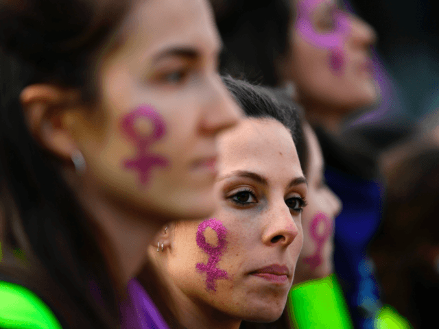 Women attend a demonstration marking International Women's Day in Madrid on March 8, 2019. - Unions, feminist associations and left-wing parties have called for a work stoppage for two hours on March 8, hoping to recreate the strike and mass protests seen nationwide to mark the same day in 2018. …