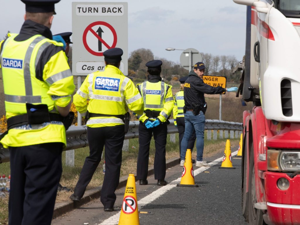 Irish Police (Garda) stop and check vechicles at the border crossing at Carrkcarnon, County Louth, Ireland, on April 9, 2020 under new powers to curb non-essential travel during the coronavirus crisis. - All vehicles leaving Northern Ireland and entering the Republic of Ireland were diverted off the motorway and checked to determine if the journey was an essential journey, as new police powers came into force in the Republic of Ireland to combat the spread of COVID-19. Emergency legislation passed in the Irish parliament two weeks ago allows the government to curb non-essential travel during the crisis. (Photo by PAUL FAITH / AFP) (Photo by PAUL FAITH/AFP via Getty Images)