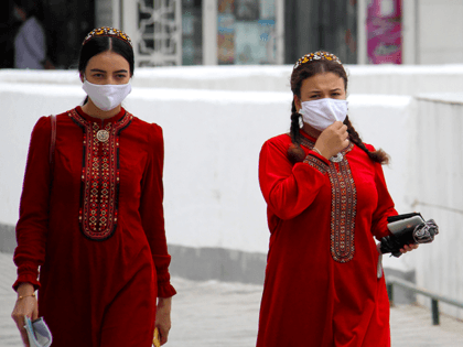 Turkmen women wearing face masks walk in Ashgabat on July 13, 2020. - Reclusive Turkmenistan on July 13 recommended that residents wear masks because of "dust" even as the government insists the country is coronavirus-free. (Photo by STR / AFP) (Photo by STR/AFP via Getty Images)