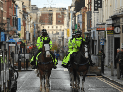 Mounted police patrol the streets on the day of an anti-vax rally protest against vaccination and government restrictions designed to control or mitigate the spread of the novel coronavirus, including the wearing of masks and lockdowns, in Liverpool, north-west England on November 14, 2020. (Photo by Oli SCARFF / AFP) …