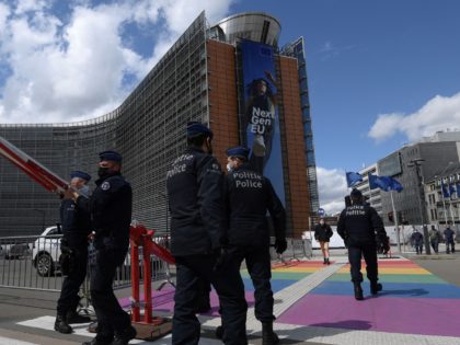 Police officers stand guard in front of the European Union Commission and Europa Consilium