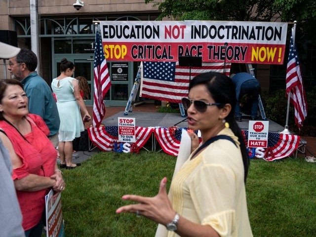 People talk before the start of a rally against "critical race theory" (CRT) being taught in schools at the Loudoun County Government center in Leesburg, Virginia on June 12, 2021. - "Are you ready to take back our schools?" Republican activist Patti Menders shouted at a rally opposing anti-racism teaching …