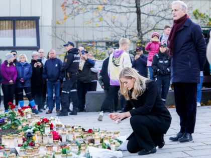 Norway's Prime Minister Jonas Gahr Store (R) and Norway's Minister of Justice and Emergency Management Emilie Enger Mehl lay flowers and candles at a makeshift memorial for the victims of the Kongsberg attack on Stortorvet in Kongsberg, Norway, on October 15, 2021. - The man who killed five people in …