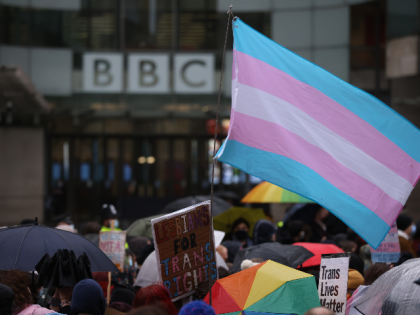 LONDON, ENGLAND - JANUARY 08: Demonstrators hold placards and wave a transgender pride fla