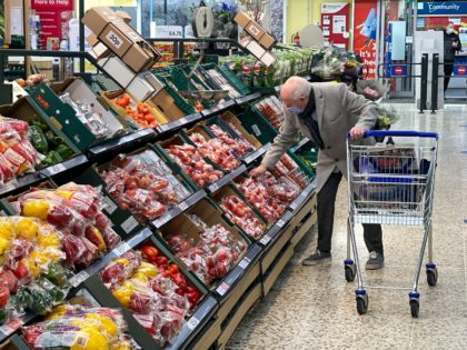 A customer shops for food items inside a Tesco supermarket store in east London on January
