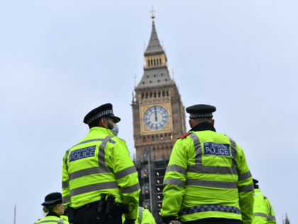 Police officers stand in sight of the Elizabeth Tower, commonly known by the name of the bell, Big Ben, as they monitor a march to protest against the Police, Crime, Sentencing and Courts Bill in London on January 15, 2022. - Marches are planned in several UK cities to support …
