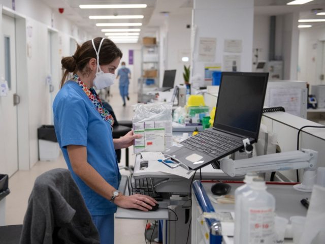 A healthcare worker works on a computer at the semi-critical respiratory unit of the Bellvitge University Hospital in Barcelona on January 19, 2022. - Milder for most but still highly contagious, Omicron has filled intensive care beds again at a hospital near Barcelona where shattered staff are still fighting a …
