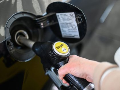 The hand of a woman holds a gasoline pump at a petrol station in Essen, western Germany on March 8, 2022. (Photo by Ina FASSBENDER / AFP) (Photo by INA FASSBENDER/AFP via Getty Images)