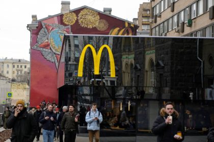 Men walk in front of the McDonald's flagship restaurant at Pushkinskaya Square - the first one of the chain opened in the USSR on January 31, 1990 - in central Moscow on March 13, 2022, McDonald's last day in Russia. - On February 24, Putin ordered Russian troops to pour …