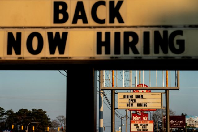 Now Hiring signs are displayed in front of restaurants in Rehoboth Beach, Delaware, on Mar