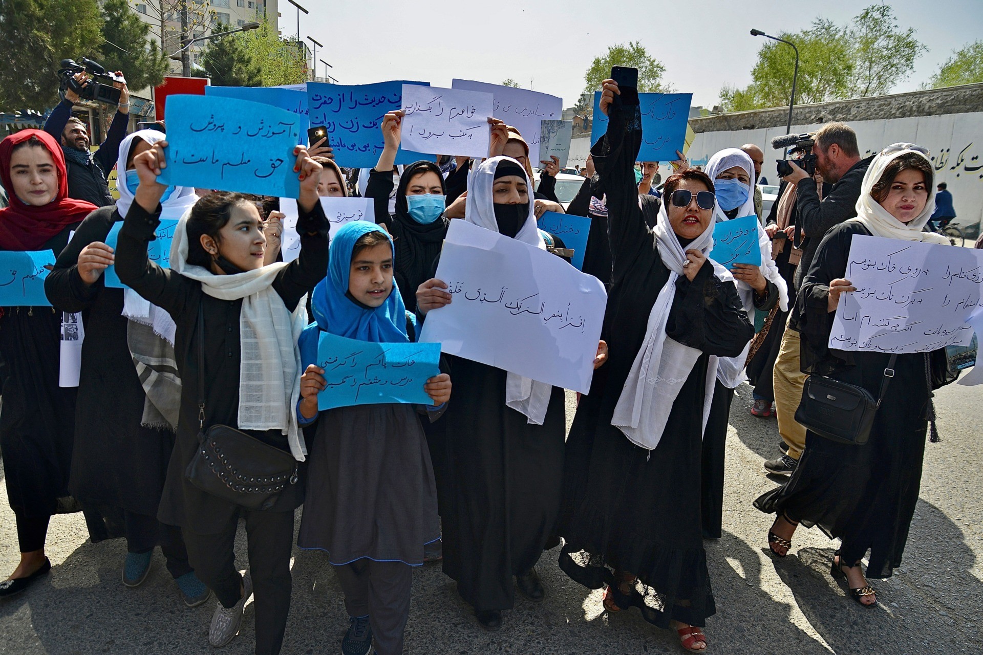 TOPSHOT - Afghan women and girls take part in a protest in front of the Ministry of Education in Kabul on March 26, 2022, demanding that high schools be reopened for girls. (Photo by Ahmad SAHEL ARMAN / AFP) (Photo by AHMAD SAHEL ARMAN/AFP via Getty Images)