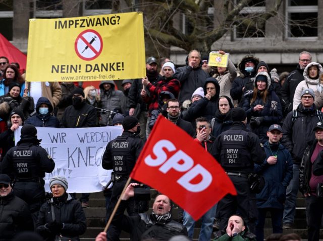 Anti-immunization protesters demonstrate against mandatory Covid-19 vaccinations on the sidelines of an election campaign event of Germany's social democratic SPD party on April 2, 2022 in Essen, western Germany, ahead of regional elections in the western federal state of North Rhine-Westphalia scheduled for May 15, 2022. (Photo by INA FASSBENDER …