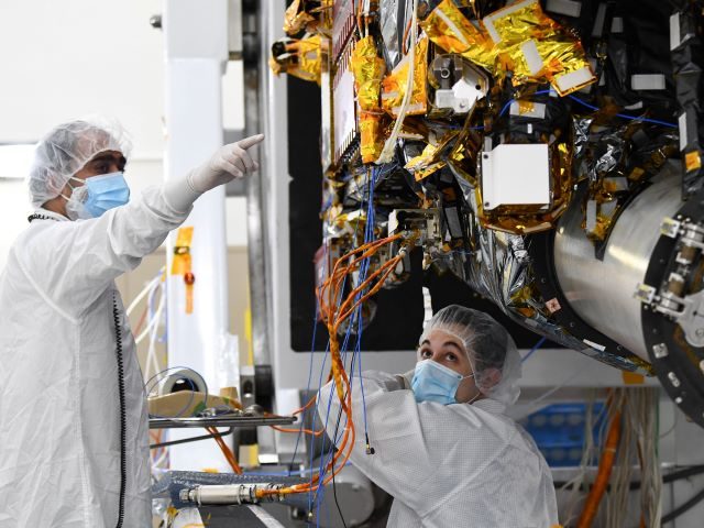 Workers prepare the Psyche spacecraft inside a clean room at NASA's Jet Propulsion Laborat