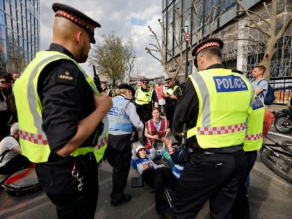 City of London police speak with activists from the climate change protest group Extinctio