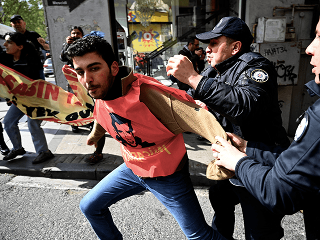 Turkish riot police officers arrest demonstrators during a May Day (Labour Day) rally mark