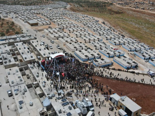 An aerial picture shows the crowd as Turkish Minister of Interior Süleyman Soylu inaugurates a housing complex for internally displaced Syrians built with Turkey's support, at the Kammouneh camps near the town of Sarmada in Syria's northwestern Idlib province, on May 3, 2022. (Photo by Aaref WATAD / AFP) (Photo …